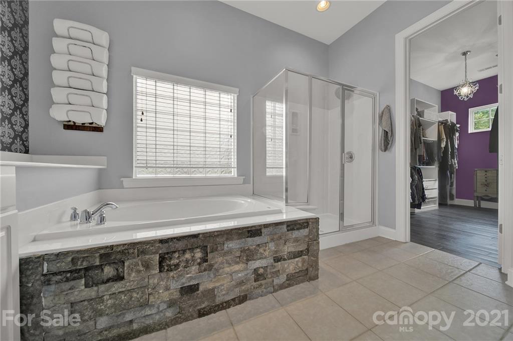 324 Miners Cove Way Fort Mill, SC 29708 - Photo 23 of 48 a spacious bathroom with a tub sink and mirror