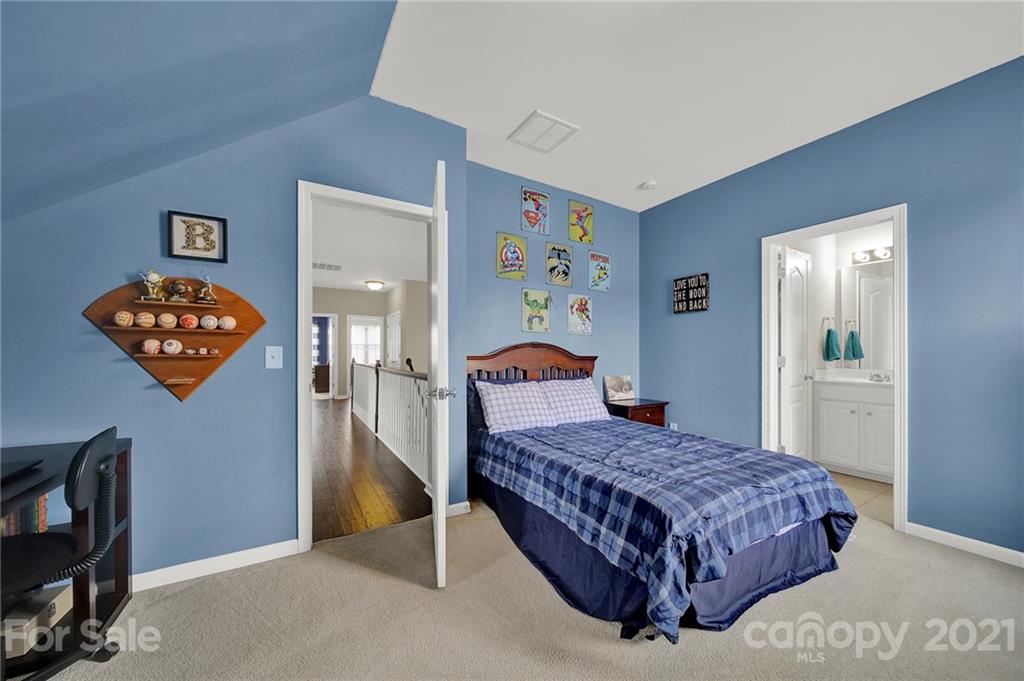 324 Miners Cove Way Fort Mill, SC 29708 - Photo 26 of 48 a bedroom with a bed and a dresser in it