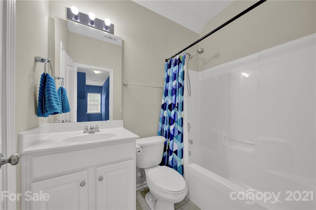 324 Miners Cove Way Fort Mill, SC 29708 - Photo 28 of 48 a bathroom with a sink a toilet a mirror and shower