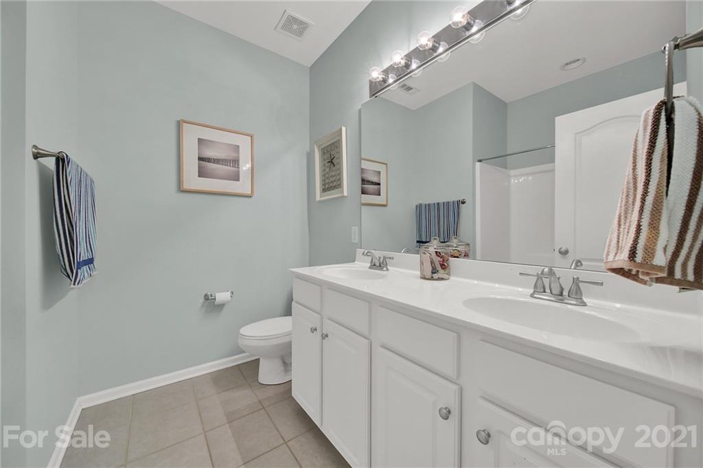 324 Miners Cove Way Fort Mill, SC 29708 - Photo 31 of 48 a bathroom with a double vanity sink toilet and a mirror