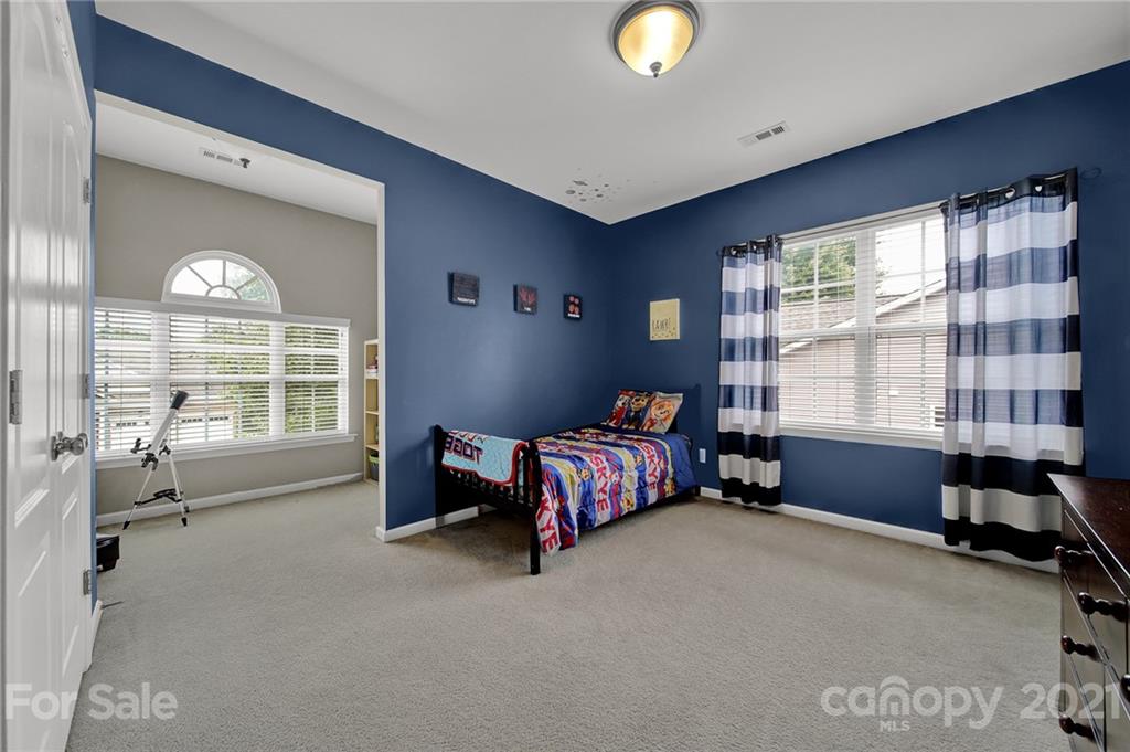 324 Miners Cove Way Fort Mill, SC 29708 - Photo 32 of 48 a spacious bedroom with a bed and a large window