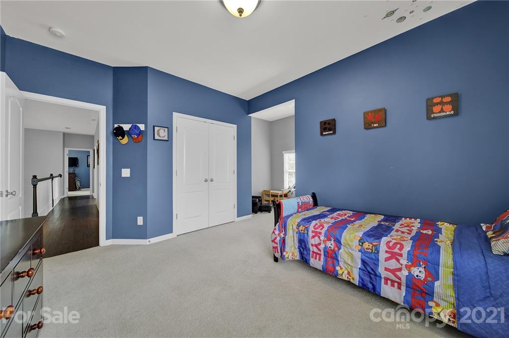 324 Miners Cove Way Fort Mill, SC 29708 - Photo 33 of 48 a bedroom with a bed and a dresser