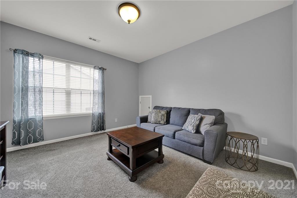 324 Miners Cove Way Fort Mill, SC 29708 - Photo 34 of 48 a living room with furniture and a window