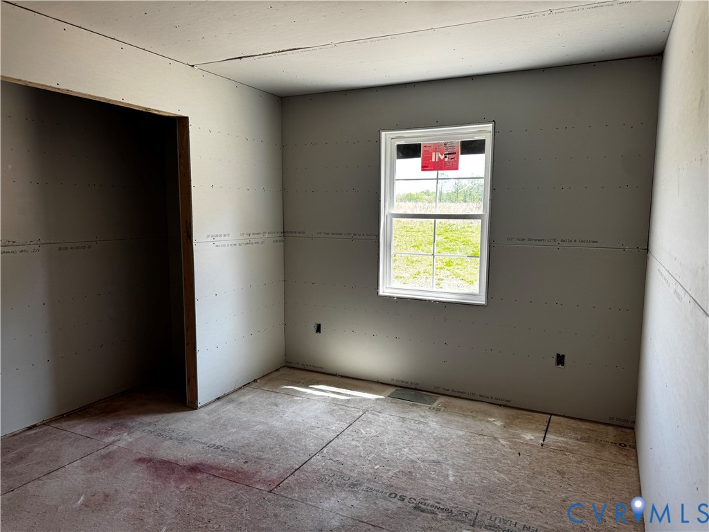 11051 Easy Street Disputanta, VA 23842 - Photo 11 of 11 an empty room with windows and painting