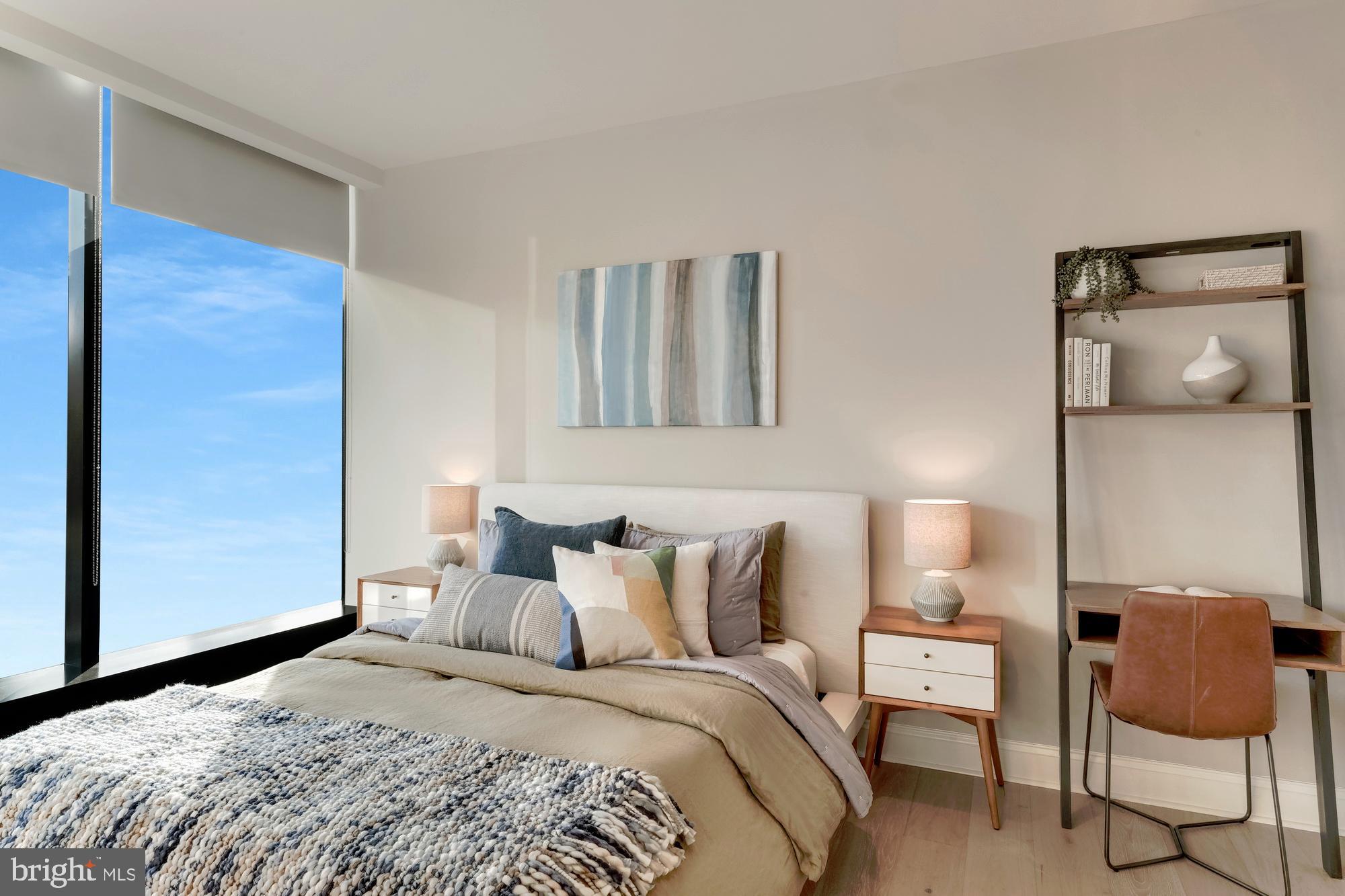 30 North 23rd Street, Unit 2003 Philadelphia, PA 19103 - Photo 17 of 42 a bedroom with a bed and chair