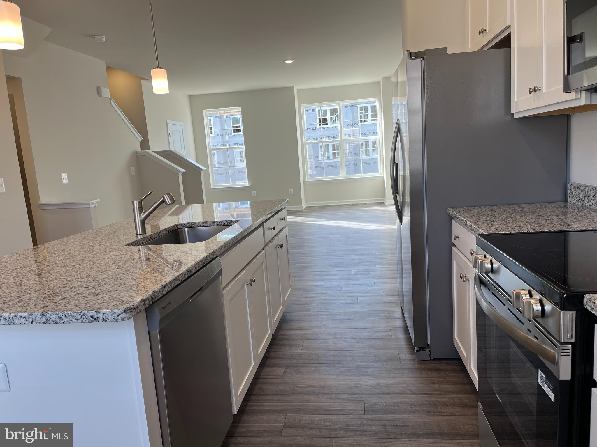 121 Canning Road Inwood, WV 25428 - Photo 17 of 38 a kitchen with granite countertop a sink and a refrigerator