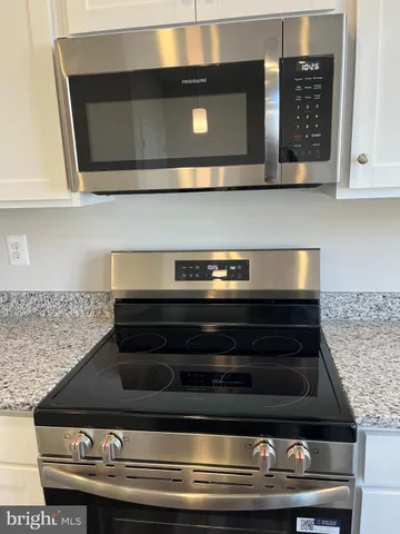 a stove top oven sitting inside of a kitchen