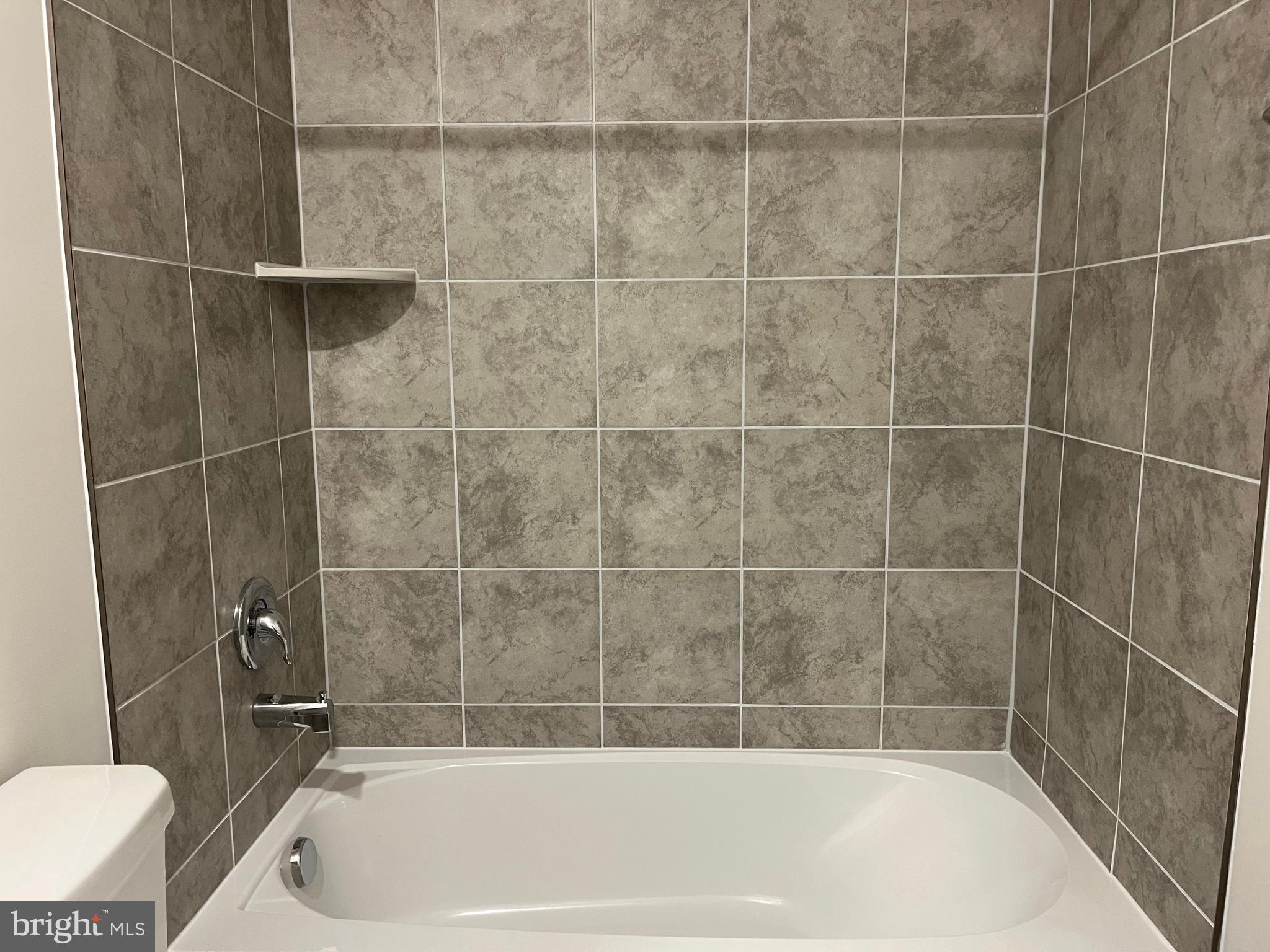 121 Canning Road Inwood, WV 25428 - Photo 29 of 38 a bath tub sitting next to a white sink and a shower