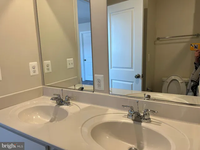 a bathroom with a sink and a large mirror