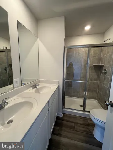 a bathroom with a sink and mirror with bathtub