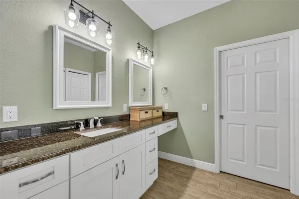 a bathroom with a double vanity sink and a mirror