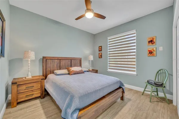 a bedroom with a bed and a chandelier