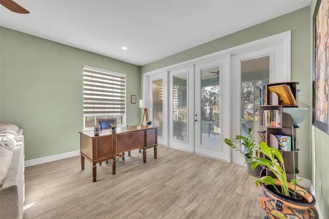a view of a workspace with furniture and a window