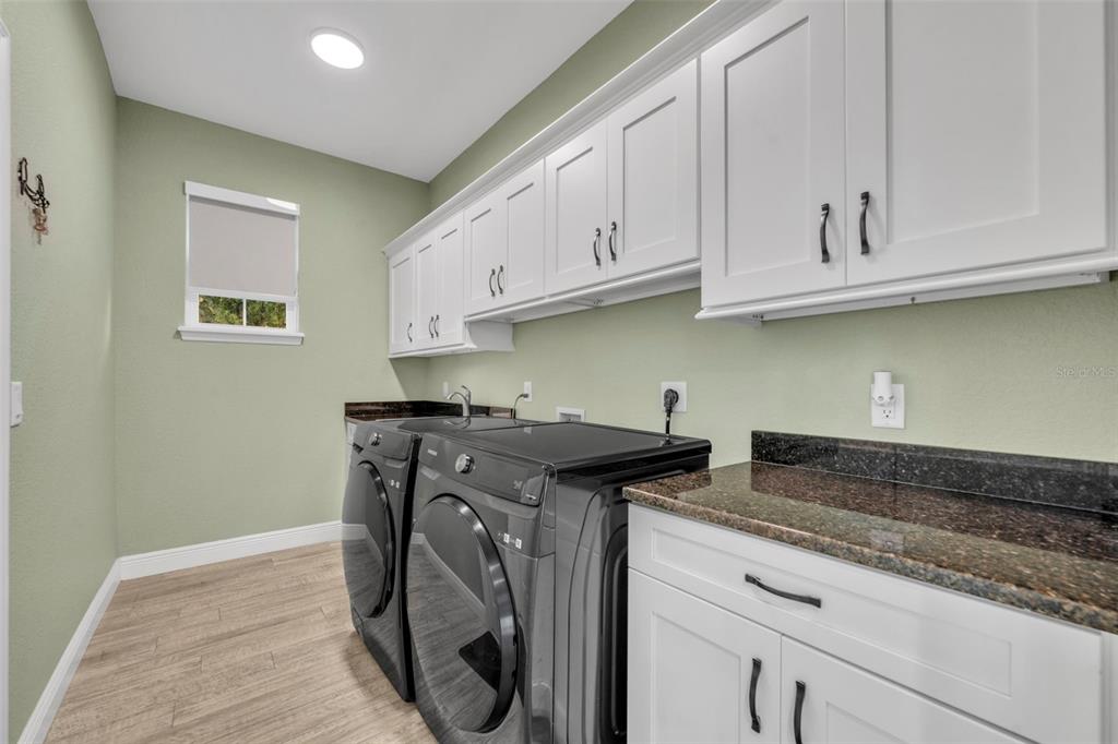 1947 North Lake Reedy Boulevard Frostproof, FL 33843 - Photo 19 of 31 a kitchen with granite countertop a sink and a stove