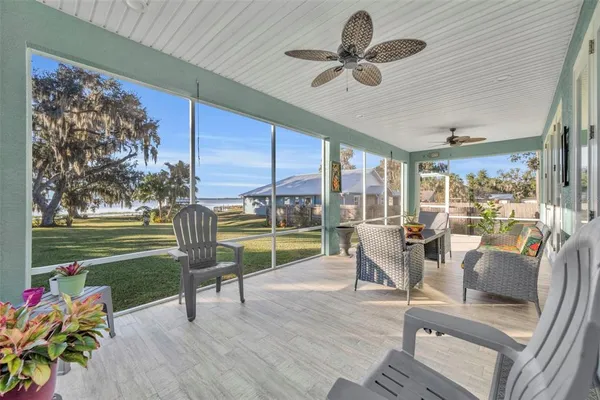 a living room filled with furniture and a floor to ceiling window