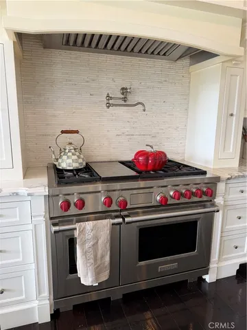 a stove top oven sitting inside of a kitchen