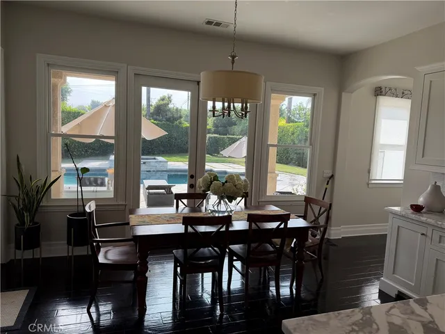 a dining room with furniture window and wooden floor