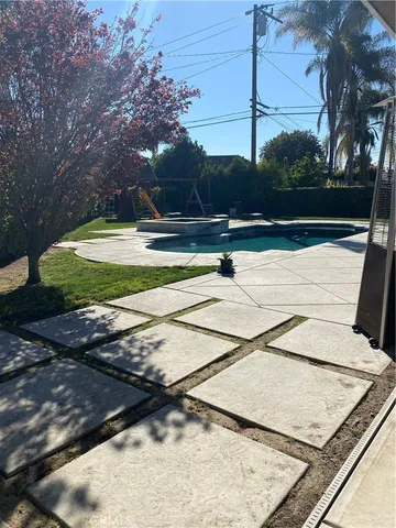 a kitchen with stainless steel appliances a sink and wooden floor