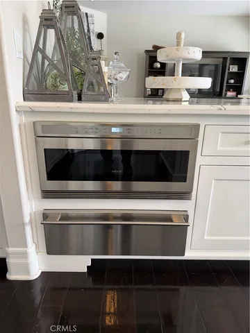 a stove top oven sitting inside of a kitchen