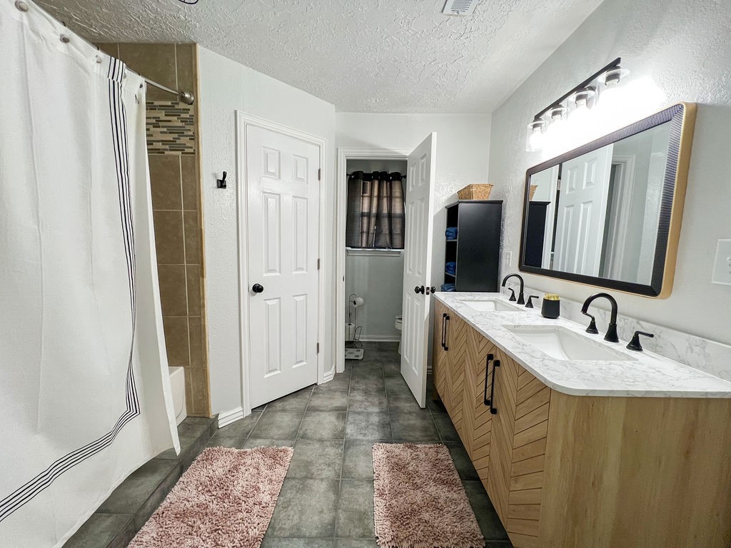 29922 Hegar Road Hockley, TX 77447 - Photo 15 of 19 a spacious bathroom with a double vanity sink and mirror