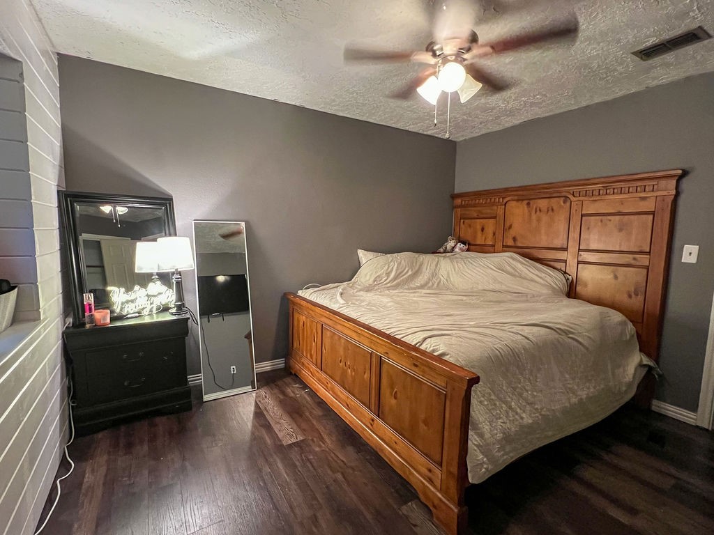 29922 Hegar Road Hockley, TX 77447 - Photo 18 of 19 a bedroom with a bed and a chandelier
