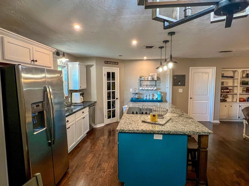 29922 Hegar Road Hockley, TX 77447 - Photo 8 of 19 a kitchen with stainless steel appliances granite countertop a refrigerator a stove and a sink