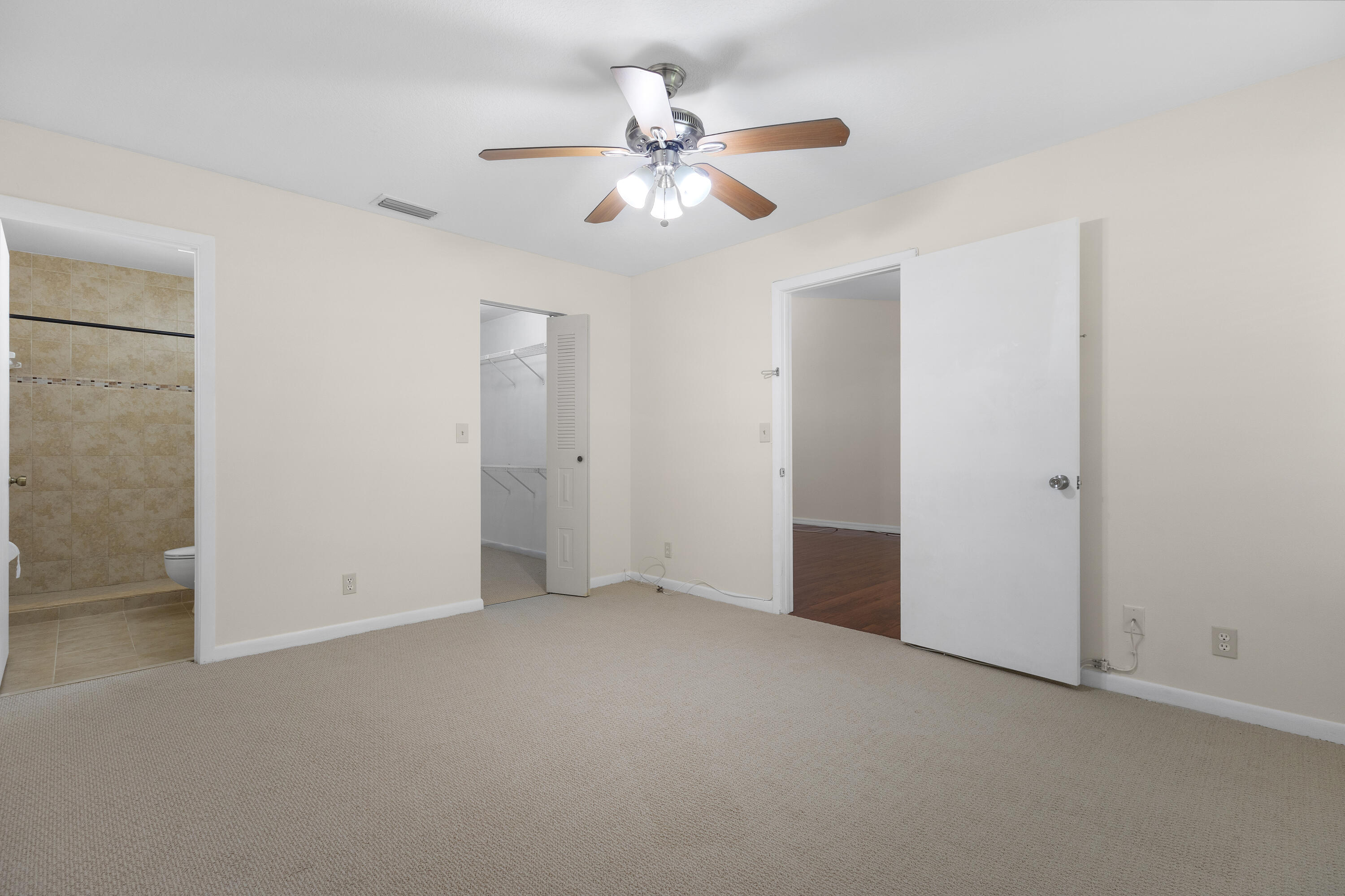 22076 Palms Way, Unit 202 Boca Raton, FL 33433 - Photo 15 of 35 an empty room with closet and a ceiling fan