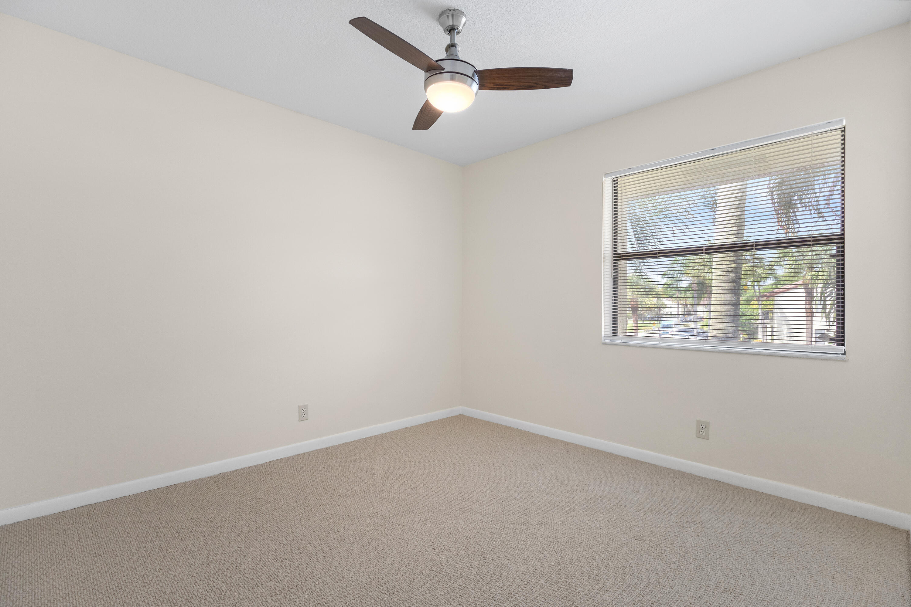 22076 Palms Way, Unit 202 Boca Raton, FL 33433 - Photo 18 of 35 an empty room with a window and a ceiling fan