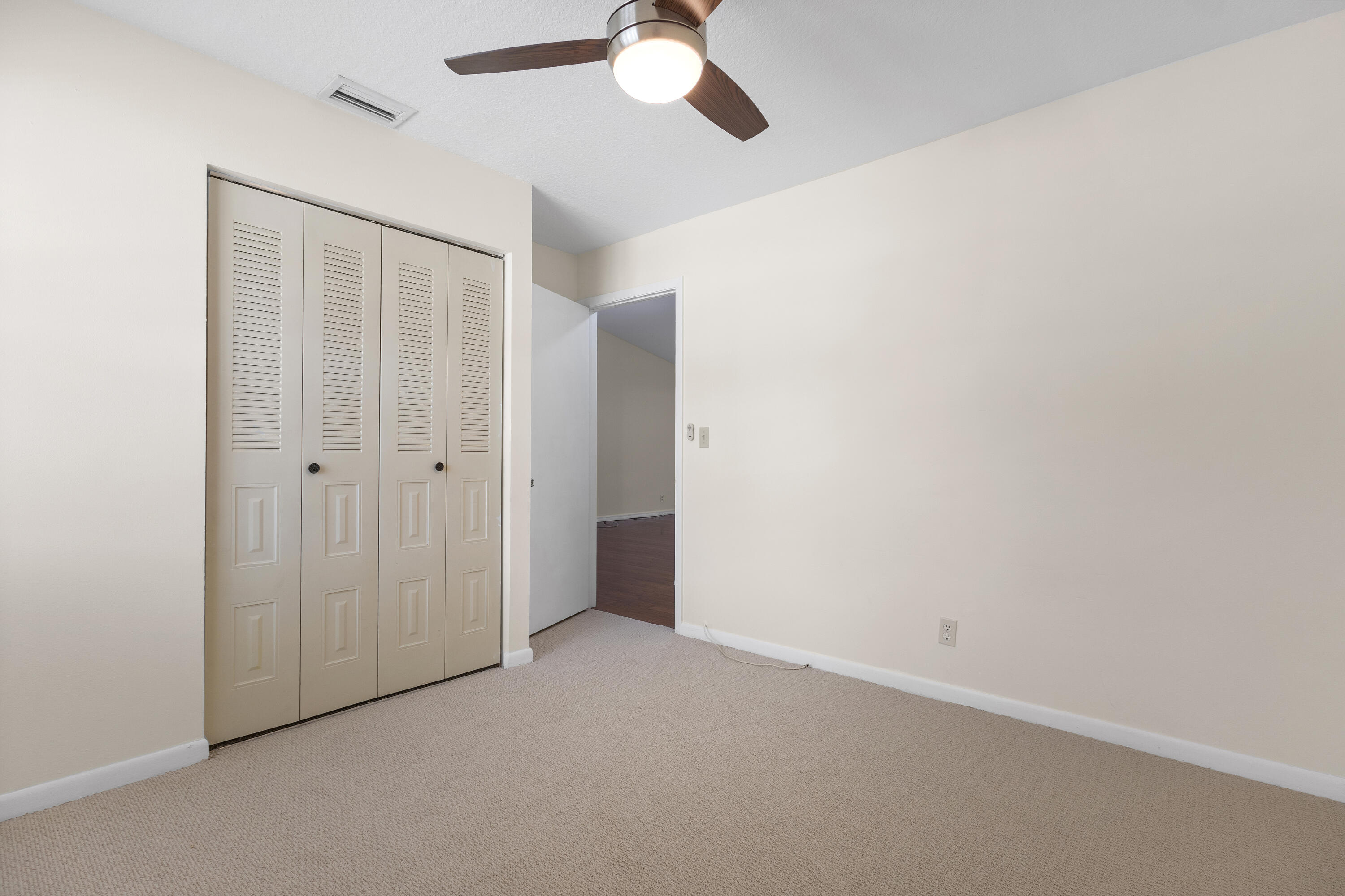 22076 Palms Way, Unit 202 Boca Raton, FL 33433 - Photo 19 of 35 an empty room with a chandelier fan