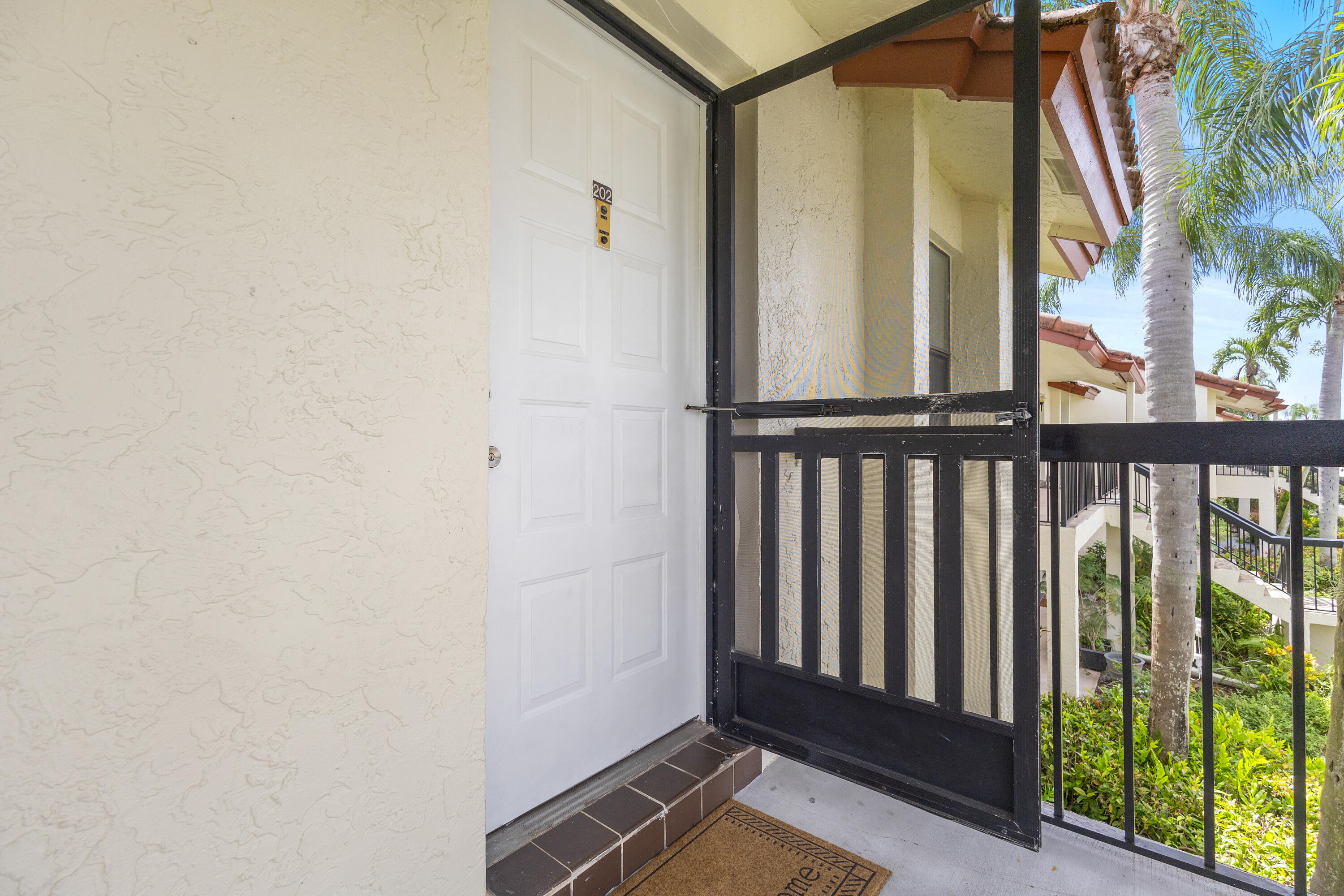 22076 Palms Way, Unit 202 Boca Raton, FL 33433 - Photo 21 of 35 a view of a porch with wooden floor