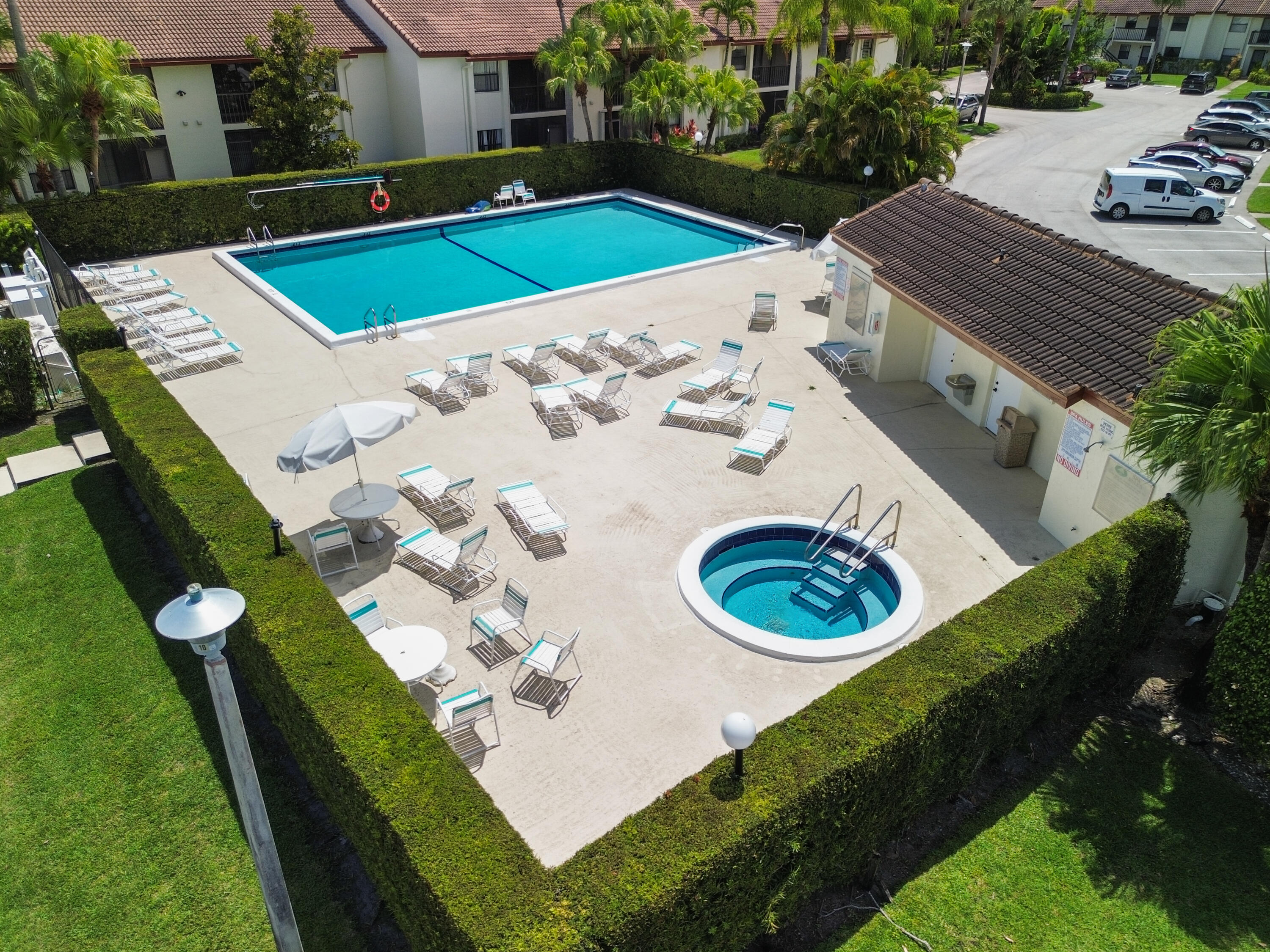 22076 Palms Way, Unit 202 Boca Raton, FL 33433 - Photo 23 of 35 a view of a swimming pool with a yard