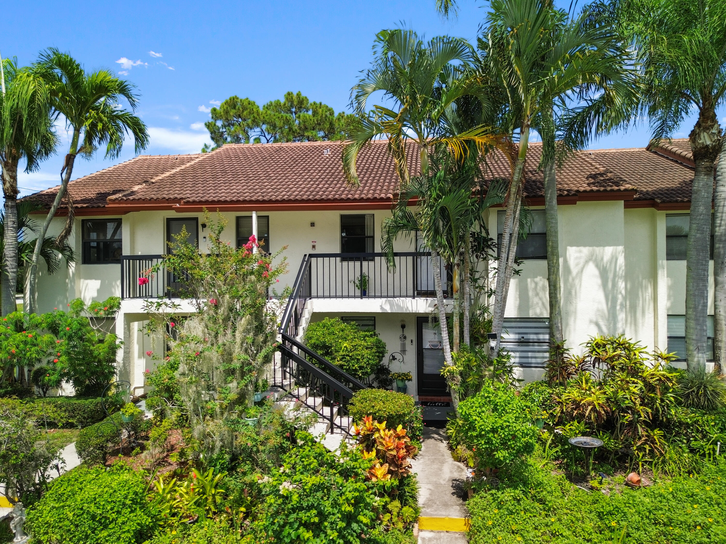 22076 Palms Way, Unit 202 Boca Raton, FL 33433 - Photo 5 of 35 a view of a house with a garden
