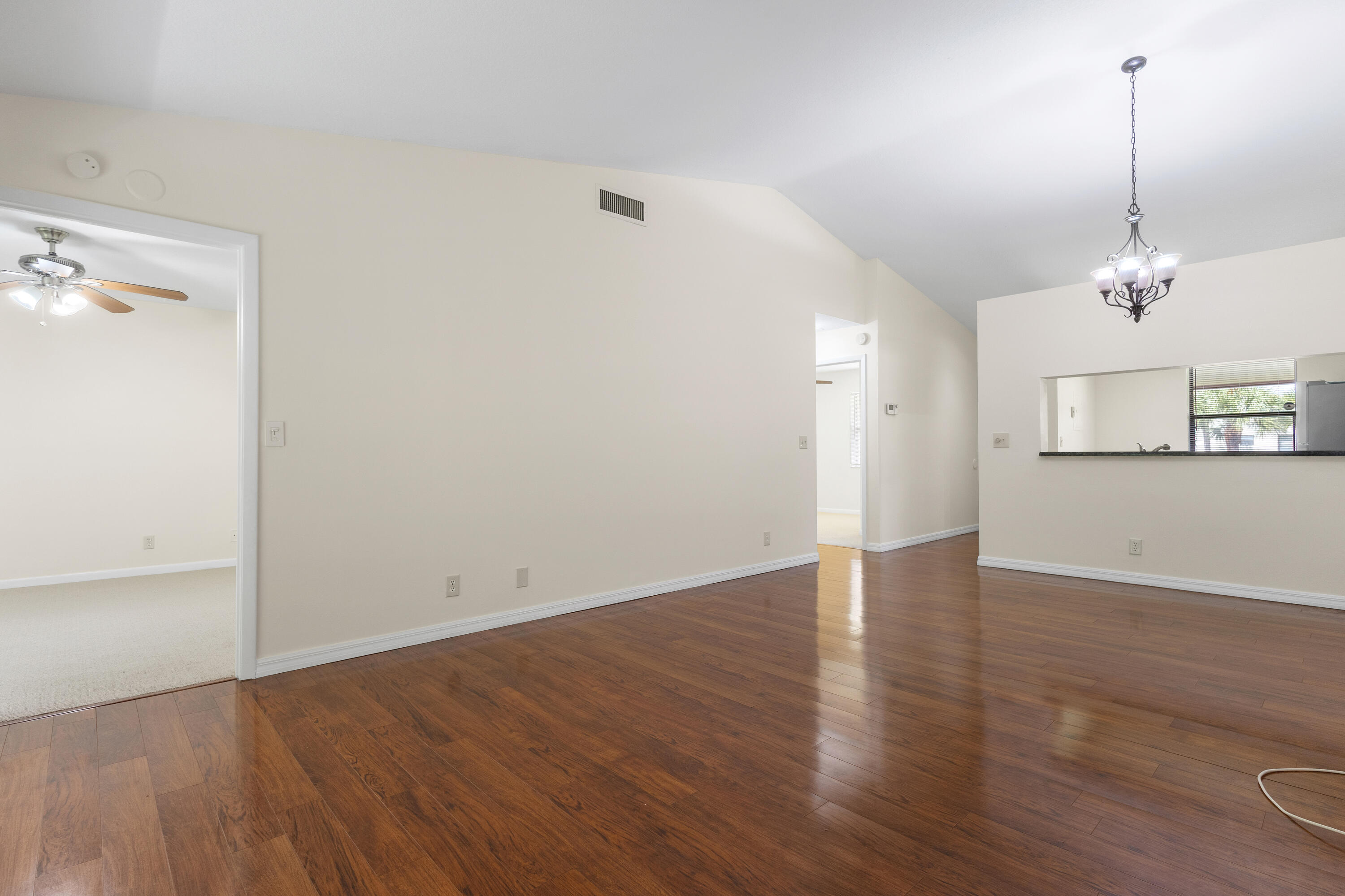 22076 Palms Way, Unit 202 Boca Raton, FL 33433 - Photo 10 of 35 an empty room with wooden floor and windows