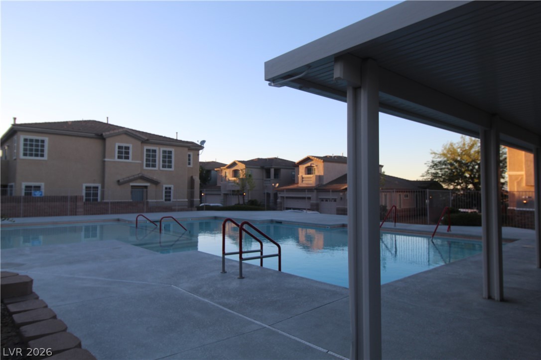 207 Priority Point Street Henderson, NV 89012 - Photo 23 of 23 A spacious community swimming pool is bordered by concrete decking and a shaded structure.