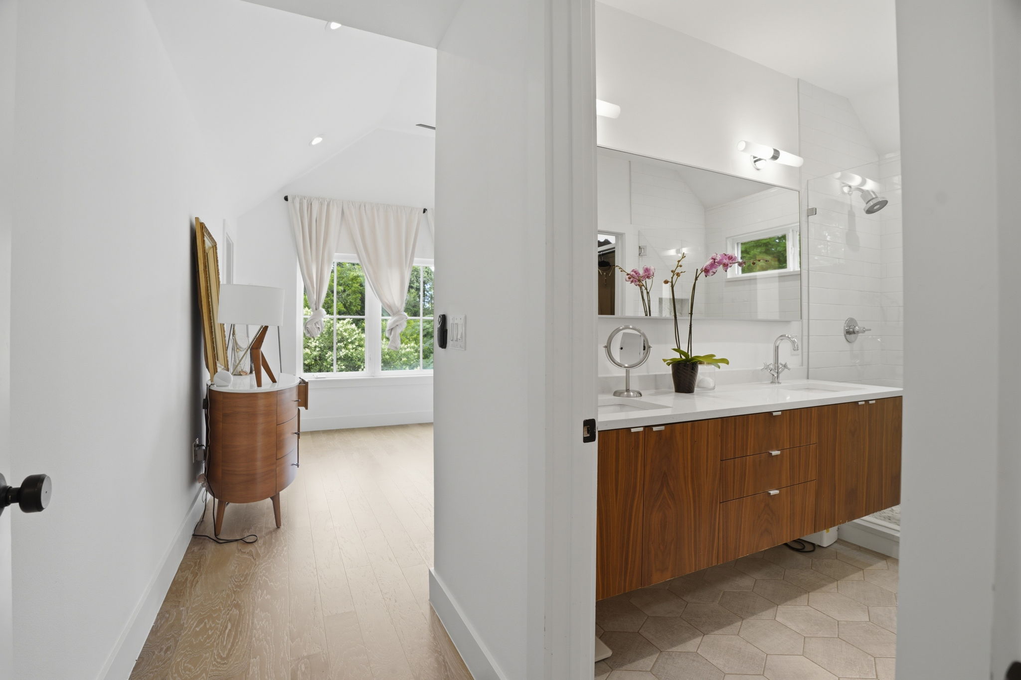 4609 Sara Drive, Unit B Austin, TX 78721 - Photo 23 of 39 A well-lit primary bathroom with floating cabinetry featuring dual vanities