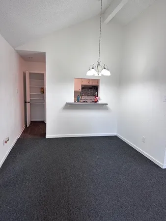 a view of a room with a sink and cabinets