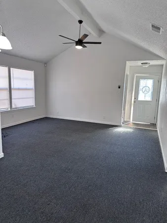 en empty room with windows and closet