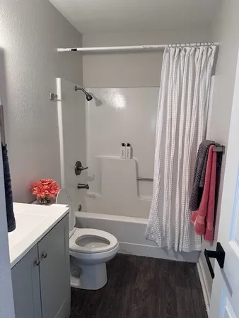 a bathroom with a toilet a sink and a shower