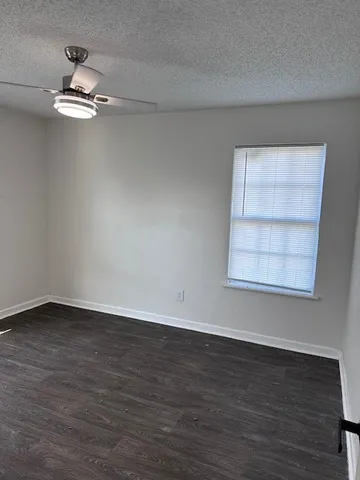 a view of a room with wooden floor and window