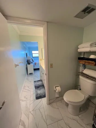a bathroom with a toilet and a shower