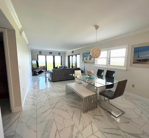 a work room with furniture a rug and a window