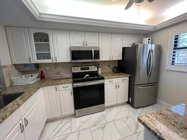 a kitchen with a sink appliances and cabinets