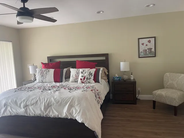 a bedroom with bed and wooden floor