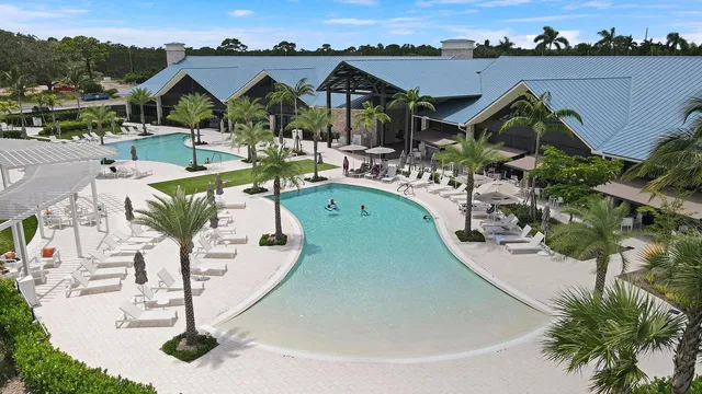 an aerial view of a house with swimming pool and mountains