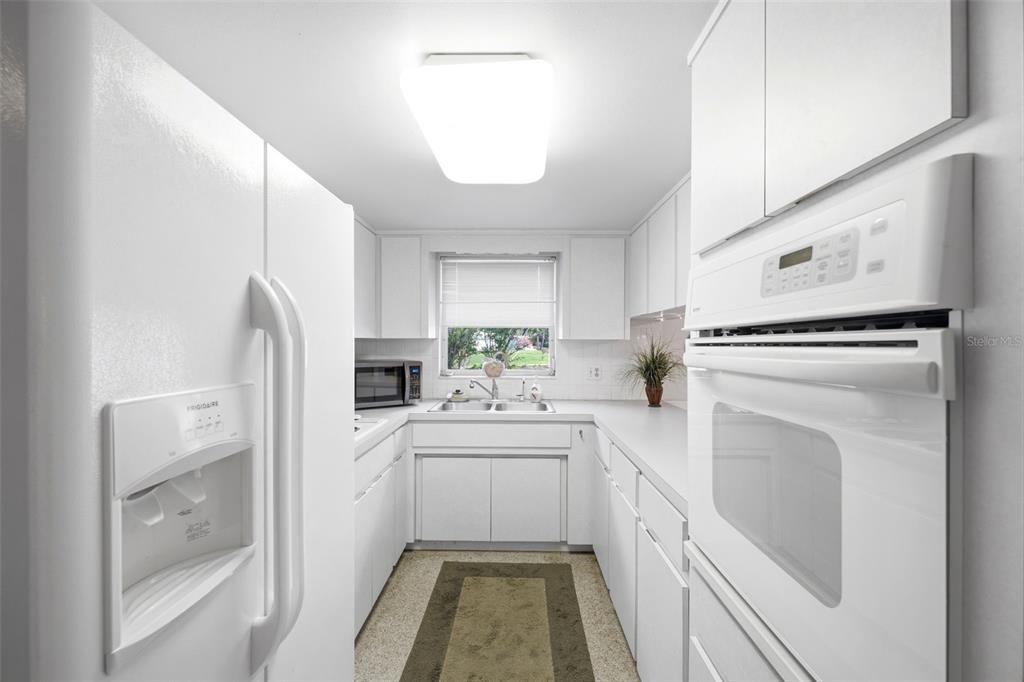 1830 South Mandarin Terrace Inverness, FL 34450 - Photo 12 of 47 a kitchen with a sink a refrigerator and cabinets