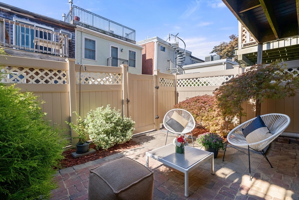 11 Wall Street Boston, MA 02129 - Photo 14 of 33 a backyard of a house with table and chairs
