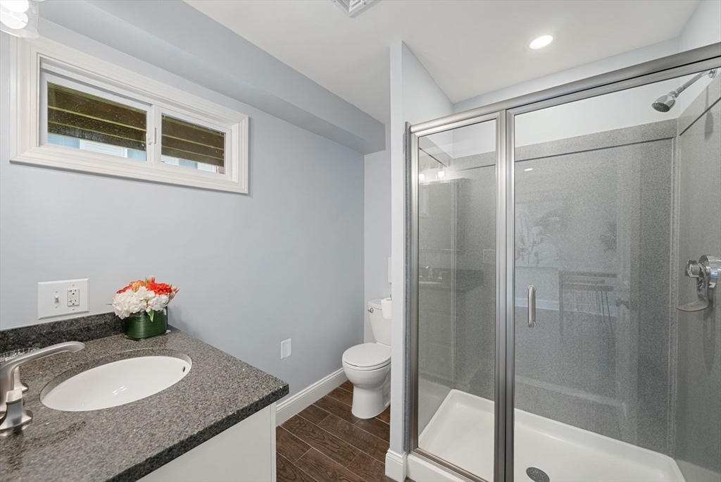 11 Wall Street Boston, MA 02129 - Photo 17 of 33 a bathroom with a granite countertop sink toilet and shower