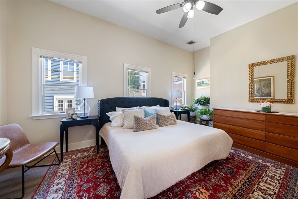 11 Wall Street Boston, MA 02129 - Photo 22 of 33 a bedroom with a bed and a chandelier