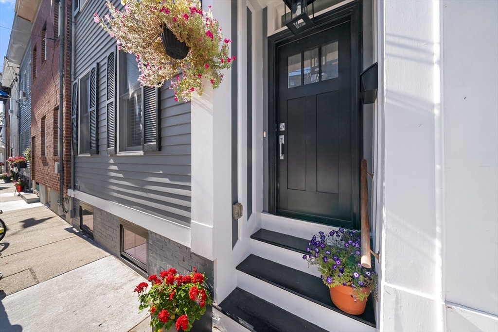 11 Wall Street Boston, MA 02129 - Photo 29 of 33 a vase with flowers sitting on a floor in front of a door