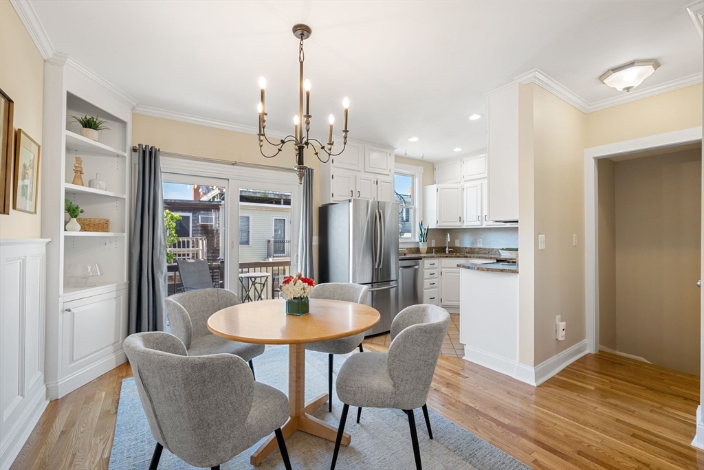 11 Wall Street Boston, MA 02129 - Photo 5 of 33 a kitchen with stainless steel appliances kitchen island granite countertop a dining table chairs and a refrigerator